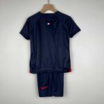 Kids PSG 2023/24 home football kit with navy blue jersey and shorts.