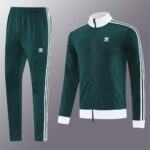 Dark green Adidas tracksuit with white stripes and logo, perfect for sports and casual wear.
