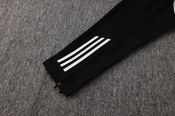 Adidas white tracksuit pants with black accents and three stripes, perfect for sports and casual wea.