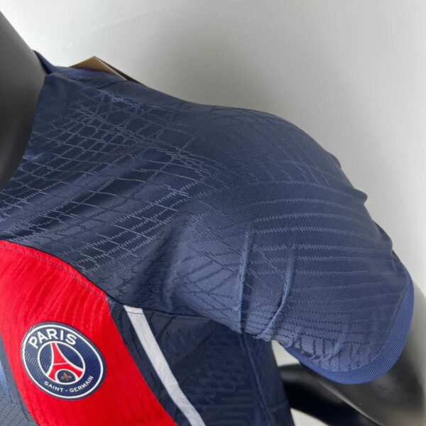 Authentic PSG home football jersey 2023/24 season, navy blue with red accents and club logo.