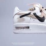 Nike Air Force 1 Low White Light Beige sneakers with black swoosh detail.