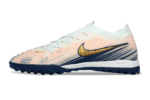 Nike Phantom GX 2 Elite TF artificial turf soccer shoe in pink, blue, and gold for optimal performan.