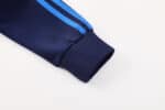 Close-up of Boca Juniors football jacket sleeve with blue stripes.