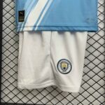 Manchester City kids home football kit 2025/26, authentic team jersey and shorts set.