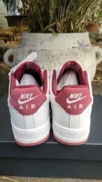 Nike Air Force 1 Low sneakers in white and red, stylish casual footwear.