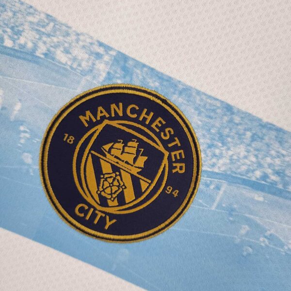 Manchester City badge on limited edition football jersey featuring Aguero 11, 2022/23 season memorab.