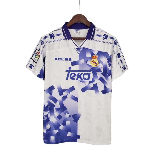 Authentic Real Madrid away football jersey with club crest and sponsor logo, perfect for fans and pl.