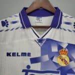 Authentic Real Madrid soccer jersey featuring club crest, sponsor logo, and team colors for football.