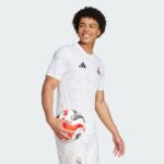 Authentic Real Madrid football jersey for fans and players, featuring team logo and modern design.
