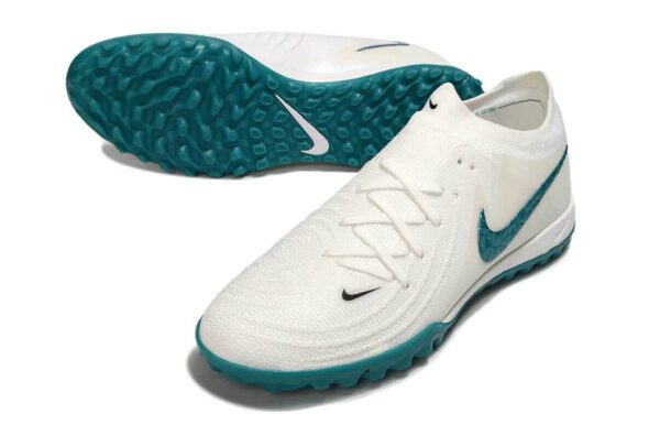 High-performance Nike Phantom GX II Elite Society football shoes in white and green for optimal grip.