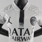 Kids PSG away football jersey 2022/23 with Qatar Airways sponsor and team logo.