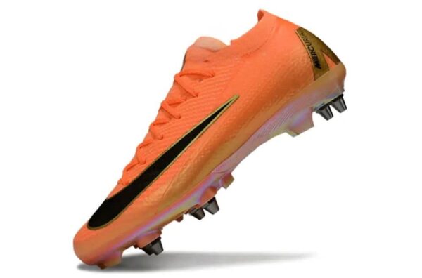 Nike Jr. Mercurial Vapor 16 Pro 'Déjà Vu' orange football cleat with black swoosh and studded sole.
