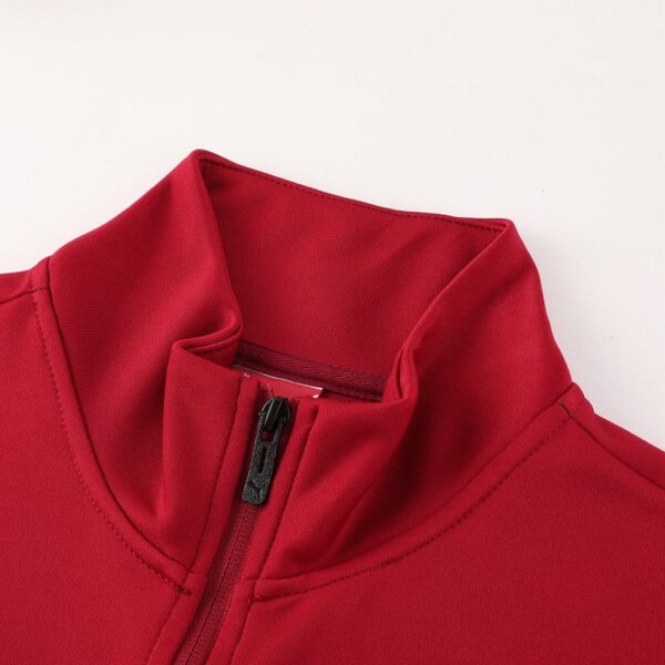 Red AC Milan pre-match jacket with high collar and zipper.