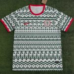 Nigeria football training jersey 2023/24, white with black geometric patterns and red accents.