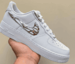 Air Force Low 1 ‘Molten Metal’ sneaker with metallic chain detail, white leather, stylish and sporty.