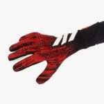 Soccer goalkeeper gloves with red and black grip design, ideal for training and matches.