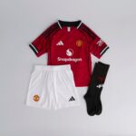 Kids Manchester United home football kit 2025/26 with jersey, shorts, and socks.