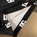 Black swimwear shorts with DG logo print for women.