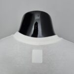 Nike Cut Shirt in two color options, white and black, designed for sports and casual wear.