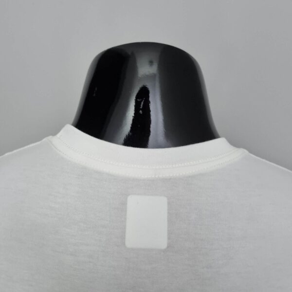 Nike Cut Shirt in two color options, white and black, designed for sports and casual wear.