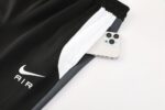 Nike Air Dri-fit jacket with black and white design, featuring a smartphone pocket. Perfect for spor.