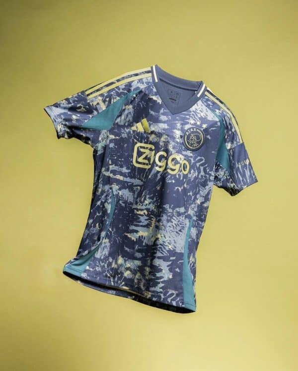 Ajax away football jersey 2024/25 with abstract blue and yellow design, official club logo and Ziggo.