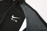 Nike Air Dri-fit Jacket in black and white with Nike logo, lightweight sportswear for active athlete.