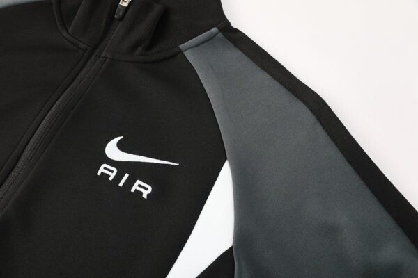 Nike Air Dri-fit Jacket in black and white with Nike logo, lightweight sportswear for active athlete.