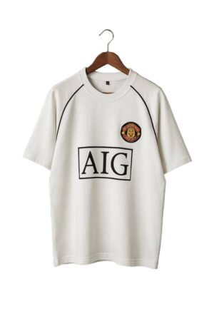 Man United white classic football jersey with club crest and AIG sponsor logo.