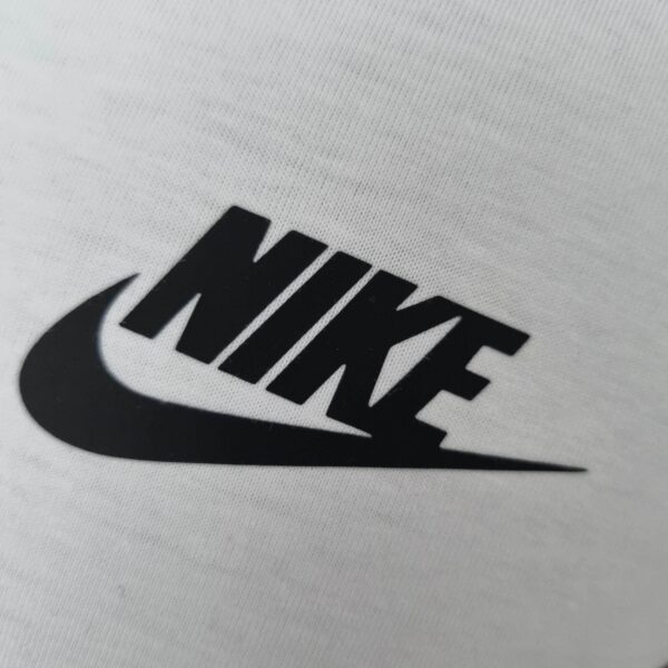 Nike logo on white fabric, two-tone shirt design.
