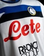 Atalanta BC away football jersey 2024/25 with club crest and sponsor logo.
