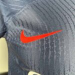 PSG 2023/24 home player jersey with Nike logo on gray fabric.