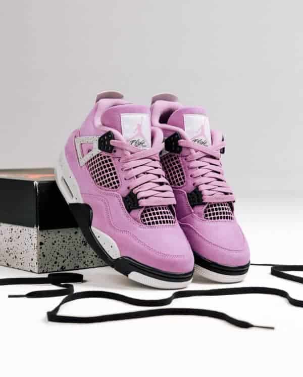 Air Jordan 4 Orchid sneakers with pink and black accents, iconic basketball shoe design.