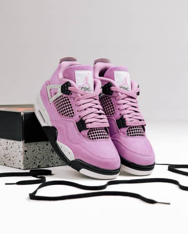 Air Jordan 4 Orchid pink and purple basketball shoes with black accents.