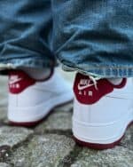 Air Force Low 1 white and red sneakers with Nike Air branding.