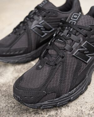 Black New Balance 1906 Cordura athletic shoes with durable fabric upper.