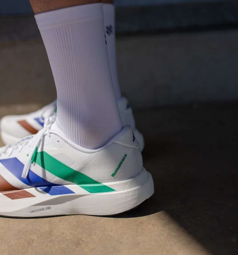 Adidas Adizero Evo SL Pharrell Humanrace sneakers in white with green and blue accents.