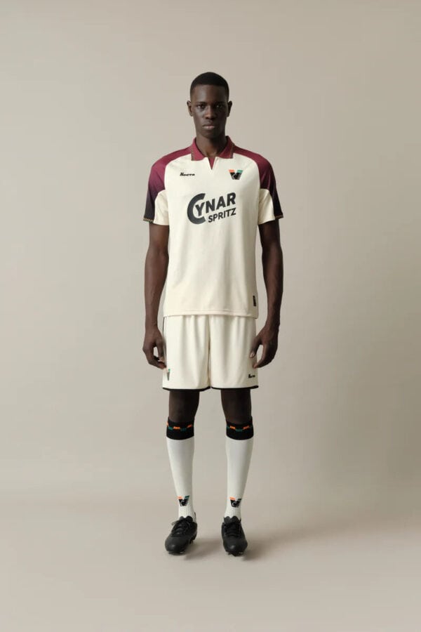 Athletic soccer player wearing UAE football jersey and shorts.