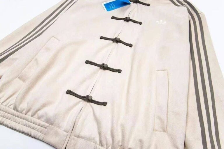 Unisex beige Adidas limited edition casual jacket with toggle closures and classic design.