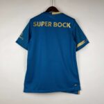 Porto away football jersey 2023/24 with blue design and gold accents.
