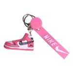 Mini Nike sneaker keychain with pink basketball and strap, perfect for sports fans and sneaker enthu.