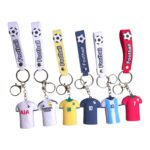 Football keychain with mini jersey replica for soccer fans.