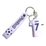 Football jersey keychain with player number 7 and soccer ball graphic, perfect for football fans and.