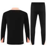 Black tracksuit with pink accents, perfect for sports and casual wear.