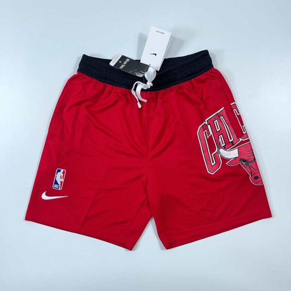 Red Chicago Bulls NBA shorts with logo, fleece material, courtside style.