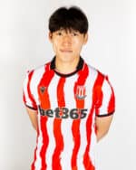Stoke City 2025/26 home football jersey with red and white vertical stripes, featuring the club cres.