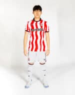 Stoke City 2025/26 home football jersey with red and white stripes, official club logo, and Bet365 s.