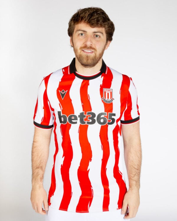 Stoke City 2025/26 home football jersey with red and white vertical stripes, official club crest, an.