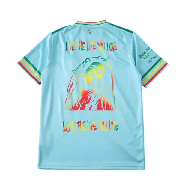 Bob Marley blue football jersey with colorful graphic and inspirational text.