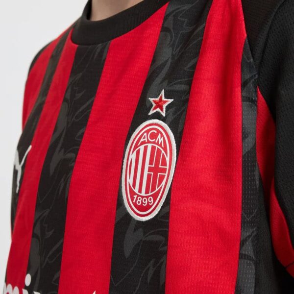 Official AC Milan youth football jersey for 2025/26 season. Red and black design with club crest and.